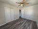 Bright bedroom featuring hard surface floors, closet, ceiling fan, and neutral wall color at 5660 86Th Ave, Pinellas Park, FL 33782