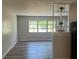 Well-lit living room with a large window, and modern vinyl plank flooring at 5660 86Th Ave, Pinellas Park, FL 33782