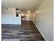 Stylish living area featuring new wood-style flooring and a partial partition wall at 5660 86Th N Ave, Pinellas Park, FL 33782