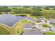 Aerial view of waterfront homes, highlighting pristine landscaping and a tranquil lake at 5670 Shorebird Br, Land O Lakes, FL 34638