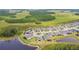 Ariel view of new home construction with lake and mature trees at 5670 Shorebird Br, Land O Lakes, FL 34638