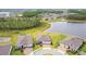 Aerial view of a new residential area with a lake and green spaces at 5670 Shorebird Br, Land O Lakes, FL 34638