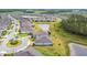 Ariel view of a residential neighborhood with lake and lush landscaping at 5670 Shorebird Br, Land O Lakes, FL 34638