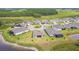 Ariel view of new home construction with lake, greenery, and cul-de-sac at 5670 Shorebird Br, Land O Lakes, FL 34638