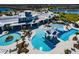 Resort-style aerial view of a community pool with cabanas, landscaping, and ample seating at 5670 Shorebird Br, Land O Lakes, FL 34638