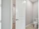Bright bathroom with a white toilet and tiled floor next to a closet at 5670 Shorebird Br, Land O Lakes, FL 34638
