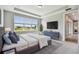 Tranquil bedroom with tray ceiling, large window, and view of the lake and outdoor landscape at 5670 Shorebird Br, Land O Lakes, FL 34638