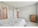 Serene bedroom featuring neutral tones and an inviting atmosphere with a view to the kitchen at 5670 Shorebird Br, Land O Lakes, FL 34638