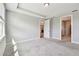 Spacious bedroom with tray ceilings, plush carpeting, and an open doorway, offering a comfortable and inviting retreat at 5670 Shorebird Br, Land O Lakes, FL 34638