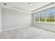 This is a spacious bedroom with a large window that lets in plenty of natural light at 5670 Shorebird Br, Land O Lakes, FL 34638