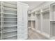 Organized walk-in closet with custom shelving and drawers, maximizing storage space at 5670 Shorebird Br, Land O Lakes, FL 34638