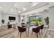 Elegant dining area with modern table, chairs, and large windows overlooking the scenic backyard at 5670 Shorebird Br, Land O Lakes, FL 34638
