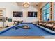 Entertaining game room featuring a billiard table, seating, and TVs for leisure at 5670 Shorebird Br, Land O Lakes, FL 34638