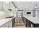 Modern kitchen features stainless steel appliances, a spacious center island, white cabinets, and stylish backsplash at 5670 Shorebird Br, Land O Lakes, FL 34638