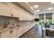 Contemporary kitchenette with white cabinets, granite countertops, undermount sinks, and stainless steel faucets at 5670 Shorebird Br, Land O Lakes, FL 34638
