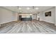 Expansive living space with kitchen, living room, and bar, connected with luxury vinyl plank floors at 5670 Shorebird Br, Land O Lakes, FL 34638