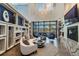Bright lobby with contemporary furniture, fireplace, and large windows overlooking a pool at 5670 Shorebird Br, Land O Lakes, FL 34638