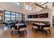 A stylish community lounge with tables, chairs, TVs, and large windows providing great natural light at 5670 Shorebird Br, Land O Lakes, FL 34638