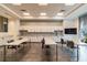 Bright meeting room featuring granite countertops, white cabinets and ample space for gatherings at 5670 Shorebird Br, Land O Lakes, FL 34638