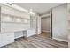 Bright office with built-in shelving, drawers, counter space, and wood-look floors at 5670 Shorebird Br, Land O Lakes, FL 34638