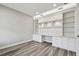 Well-lit office space with built-in shelving and wood-look floors at 5670 Shorebird Br, Land O Lakes, FL 34638