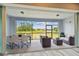 Enclosed patio showcasing outdoor seating area with views of the lake and community landscape at 5670 Shorebird Br, Land O Lakes, FL 34638