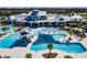 Aerial view of a luxurious community pool with ample seating, cabanas, and well-manicured landscaping at 5670 Shorebird Br, Land O Lakes, FL 34638