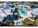 Aerial view of community pool area with modern design, including a hot tub, pool, and gazebo at 5670 Shorebird Br, Land O Lakes, FL 34638
