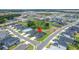 An aerial view showcases a community with homes, manicured lawns, and scenic water features at 5828 Clairwood Ct, Palmetto, FL 34221