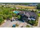 Stunning aerial view of the community pool and clubhouse, surrounded by lush landscaping and trees at 5828 Clairwood Ct, Palmetto, FL 34221