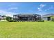 Expansive backyard features lush lawn and a screened-in pool enclosure for outdoor enjoyment at 5828 Clairwood Ct, Palmetto, FL 34221