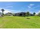 Lush backyard view, showcasing a screened-in pool area and well-maintained landscaping at 5828 Clairwood Ct, Palmetto, FL 34221