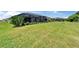 Generous backyard with green grass extending towards a screened-in patio, perfect for relaxing at 5828 Clairwood Ct, Palmetto, FL 34221
