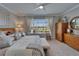 Bright bedroom with a ceiling fan, window and decorative furniture at 5828 Clairwood Ct, Palmetto, FL 34221