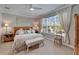 Bright bedroom with a ceiling fan, window, area rug and decorative furniture at 5828 Clairwood Ct, Palmetto, FL 34221
