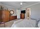 Cozy bedroom featuring a large armoire, dresser and a view into the bathroom at 5828 Clairwood Ct, Palmetto, FL 34221