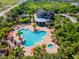 Aerial view of a community pool, surrounded by lush tropical landscaping at 5828 Clairwood Ct, Palmetto, FL 34221