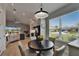 Bright dining area features a dark wood table with white chairs overlooking the modern kitchen at 5828 Clairwood Ct, Palmetto, FL 34221