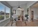 Dining room features an elegant dark wood table, white cabinet and a bright window showing the exterior view at 5828 Clairwood Ct, Palmetto, FL 34221