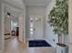 Bright foyer featuring wood-look tile flooring, a decorative houseplant, and views into the adjacent living area at 5828 Clairwood Ct, Palmetto, FL 34221