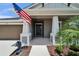 Welcoming front entrance showcasing elegant columns, lush landscaping, and a charming dolphin statue at 5828 Clairwood Ct, Palmetto, FL 34221
