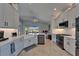 Modern, spacious kitchen boasts white cabinets, stainless steel appliances, and a farm sink overlooking the screened-in patio at 5828 Clairwood Ct, Palmetto, FL 34221