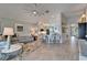 Open-concept living room with tile flooring, modern furnishings, and adjacent kitchen area at 5828 Clairwood Ct, Palmetto, FL 34221
