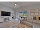Comfortable living room area with tile floors, cozy seating, and backyard views at 5828 Clairwood Ct, Palmetto, FL 34221