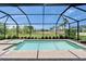 Sparkling pool area featuring a spa, screened enclosure, and green surroundings at 5828 Clairwood Ct, Palmetto, FL 34221