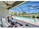 Screened-in pool area with spa, patio seating, and lush landscaping at 5828 Clairwood Ct, Palmetto, FL 34221
