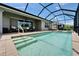 Inviting screened-in pool with spa, outdoor seating area, and manicured landscaping at 5828 Clairwood Ct, Palmetto, FL 34221