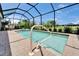 Enclosed pool area with a spa, featuring outdoor seating and lush surroundings at 5828 Clairwood Ct, Palmetto, FL 34221