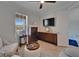 Well-lit sitting room featuring neutral tones, a ceiling fan, modern furniture, and a view of the outdoors at 5828 Clairwood Ct, Palmetto, FL 34221