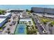 Aerial view of community amenities with tennis courts, pool, lawn bowling, and parking at 5925 Shore S Blvd # 602, Gulfport, FL 33707